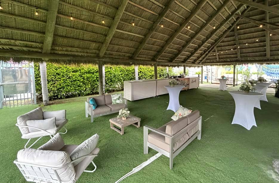 Under the Pavilion: a lounge setup with a bar and string lights